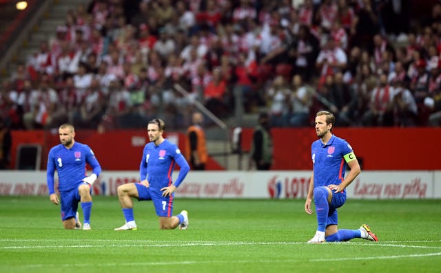 England’s Luke Shaw, Jack Grealish and Harry Kane, left to right, take the knee before a World Cup qualifier against Poland