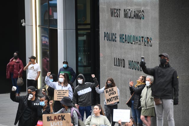 People gather outside the West Midlands Police headquarters during a Black Lives Matter protest rally in Birmingham