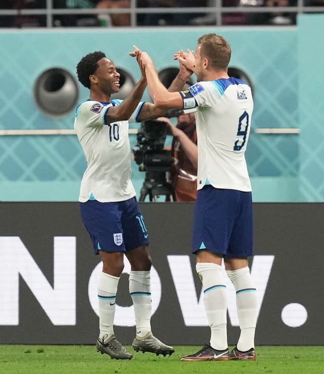 Harry Kane celebrates with Raheem Sterling (left) against Iran 