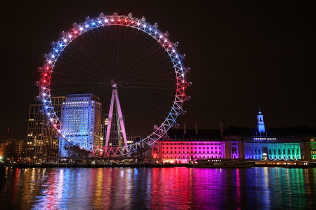 The London Eye and buildings along the South Bank are lit up with the colours of the Union flag, during a nationwide clap in honour of Captain Sir Tom Moore