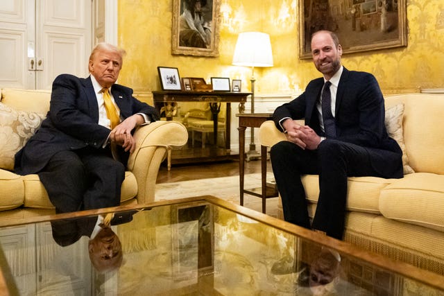 The Prince of Wales sits on a sofa near US President-elect Donald Trump