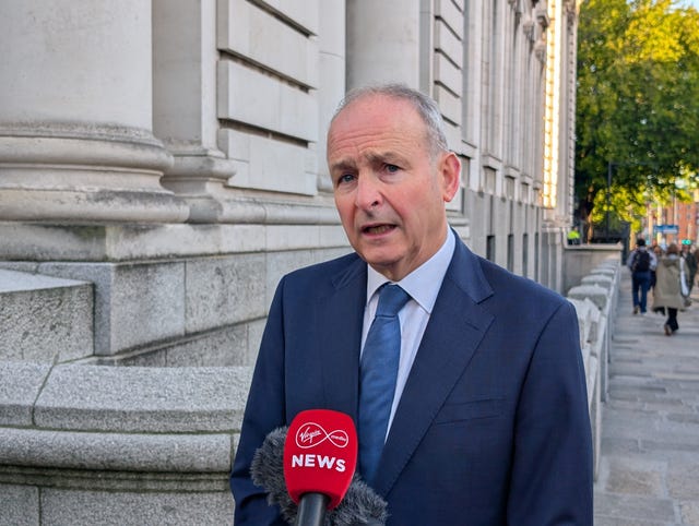Taoiseach Micheál Martin speaking into mics outside