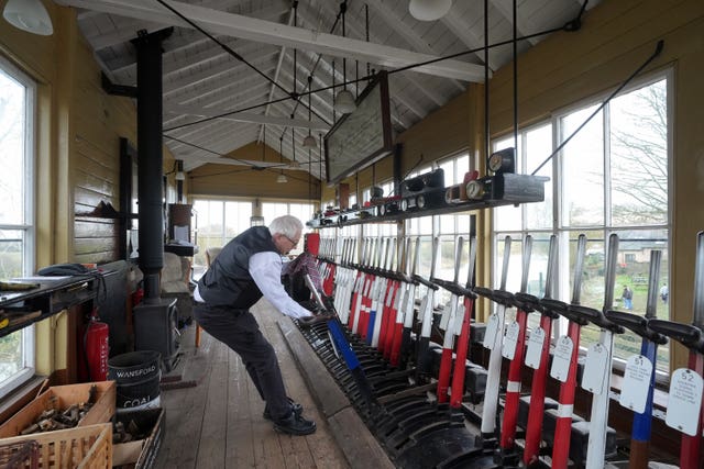 A signaller at work in the signal box at Wansford station