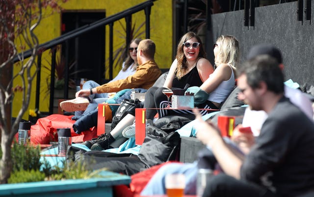 Customers enjoy a drink at the Escape to Freight Island bar in Depot Island, Manchester (Martin Rickett/PA) 