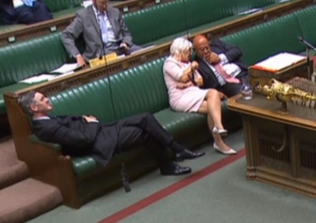 Jacob Rees-Mogg reclining on his seat in the House of Commons.