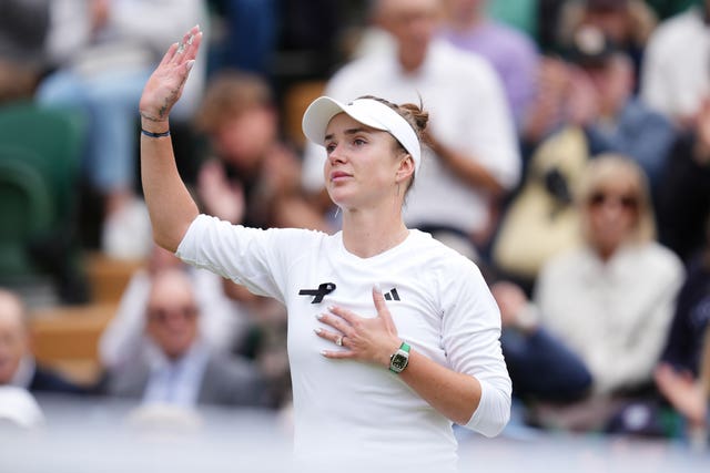 Elina Svitolina waves to the crowd with one hand and puts the other over her chest