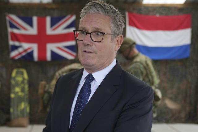 Sir Keir Starmer with British and Netherlands flags in the background