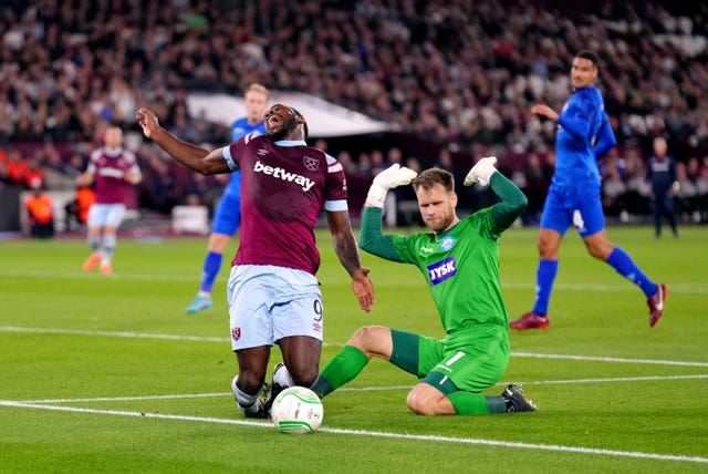 Silkeborg goalkeeper Nicolai Larsen, right, fouls West Ham’s Michail Antonio to concede a penalty