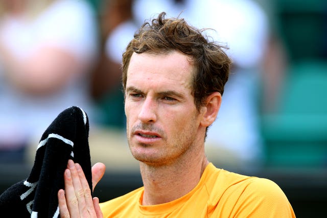 Andy Murray wipes his hands on a towel