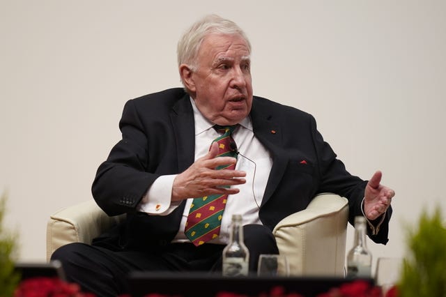 Lord Murphy seated, gesturing with his hands while speaking