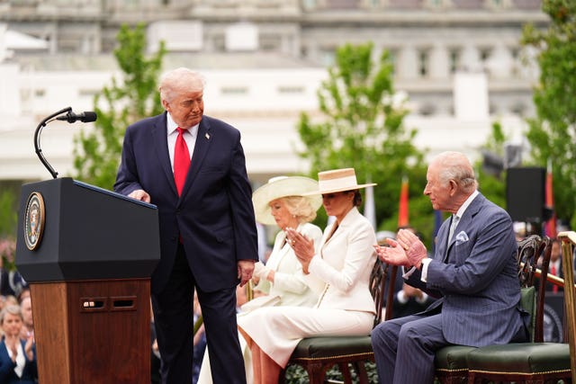 The King claps after US President Donald Trump turns back to look at him as he delivers a speech