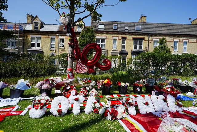 Tributes at Anfield in memory of Diogo Jota, with white flowers spelling out 