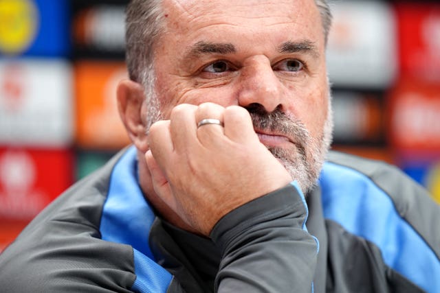 Ange Postecoglou listens to a question as he speaks at a press conference