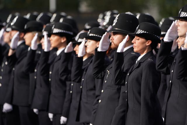 A line of uniformed police officers.