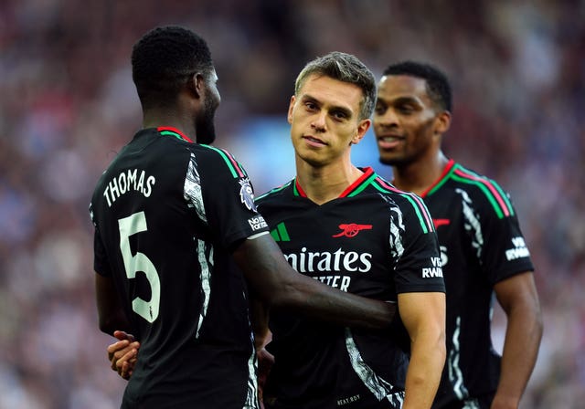 Thomas Partey, left, congratulates Leandro Trossard as the Arsenal winger barely celebrates his goal against Aston Villa