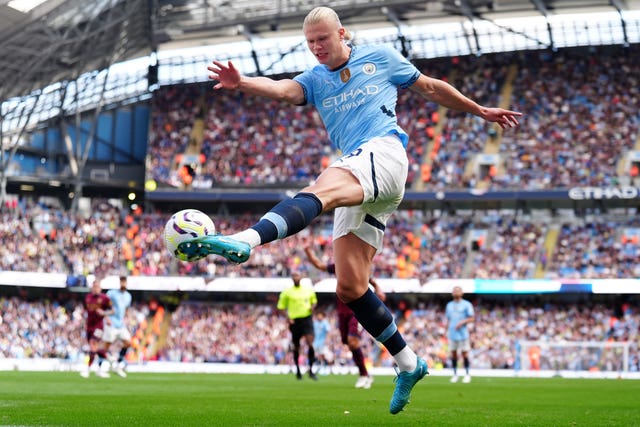 Erling Haaland kicking the ball for Manchester City