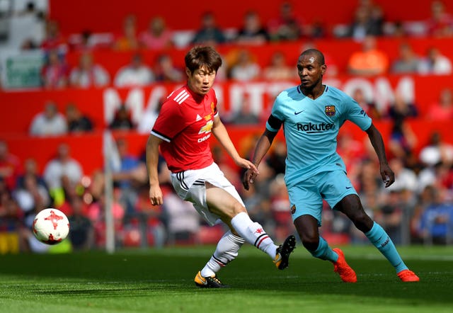 Barcelona’s Eric Abidal (right) and Manchester United’s Ji-Sung Park during a legends match
