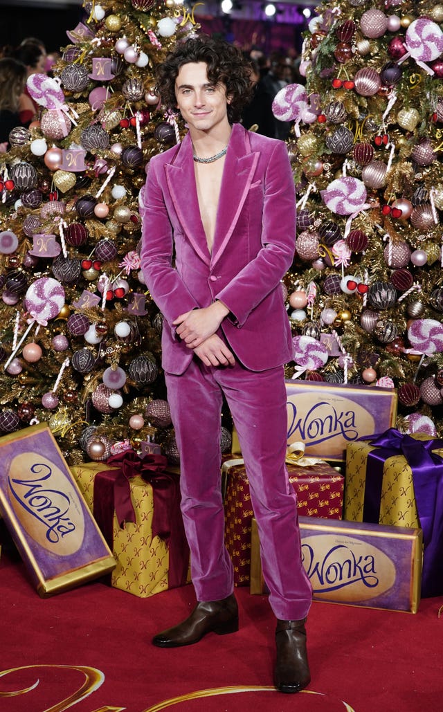 Timothee Chalamet, dressed in a purple suit, arrives for the world premiere of Wonka