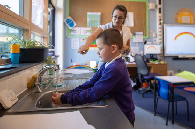 A pupil washes his hands