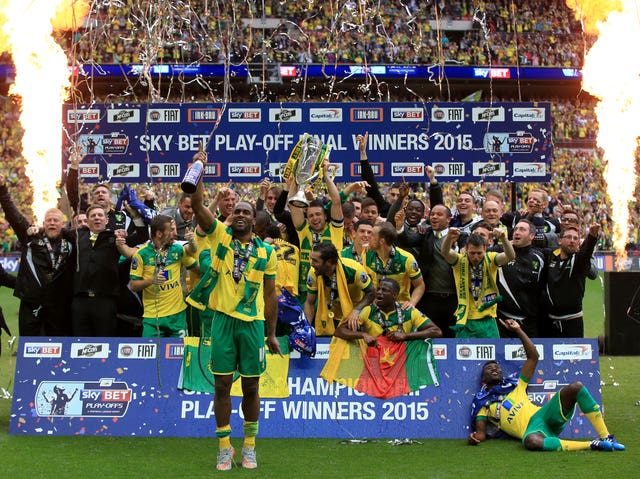 Norwich City’s Cameron Jerome celebrates in front of players and staff celebrate at Wembley