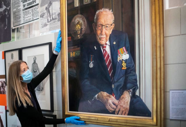 A portrait of Captain Sir Tom Moore hangs in the National Army Museum London (Victoria Jones/PA)
