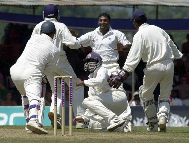 Sri Lankan bowler Muttiah Muralitharan, centre, celebrates with team-mates before England captain Nasser Hussain, left, is ultimately given not out