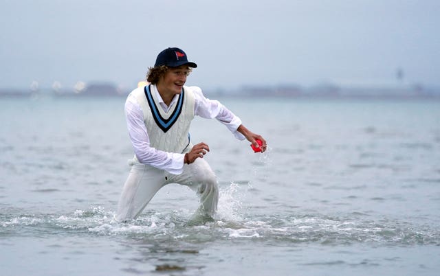 A fielder wades in to help his colleagues (Andrew Matthews/PA)