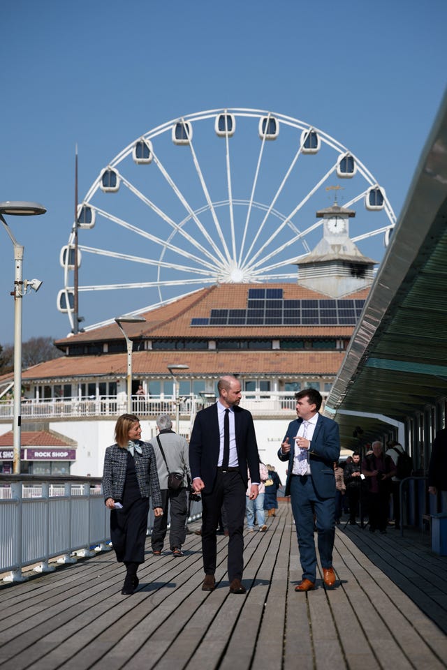The Prince of Wales walks with Hazel Detsiny, executive director of Homewards, as he arrives for a visit to see Homewards’ groundbreaking youth homelessness work at Bournemouth Pier in Dorset