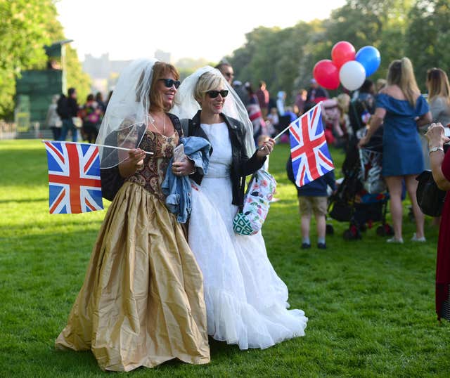 It's a nice day for a white wedding for these two spectators (David Mirzoeff/PA)