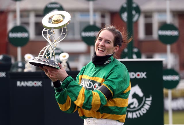 Jockey Rachael Blackmore receives the Randox Grand National Handicap Chase trophy after winning on Minella Times during Grand National Day of the 2021 Randox Health Grand National Festival at Aintree Racecourse, Liverpool