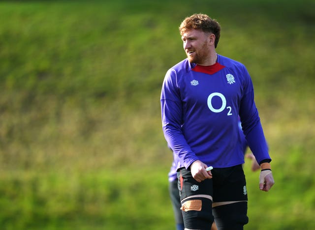 Ollie Chessum looks to his right and smiles during a training session