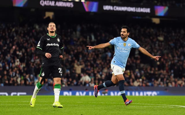 Manchester City’s Ilkay Gundogan stretches out his arms to celebrate scoring their side’s second goal against Feyenoord