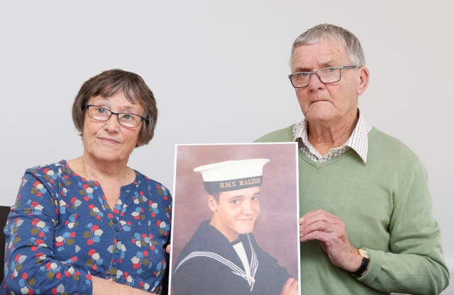 Margaret and David Parkes holding a photograph of their son Simon Parkes 