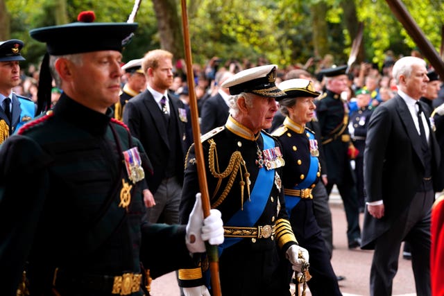 King Charles III, the Princess Royal and The Duke of Sussex follow the State Gun Carriage carrying the Queen's coffin after her funeral