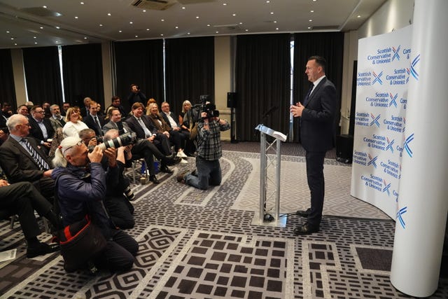 Russell Findlay addresses an audience from a lectern