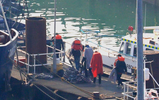 A group of men are brought to shore