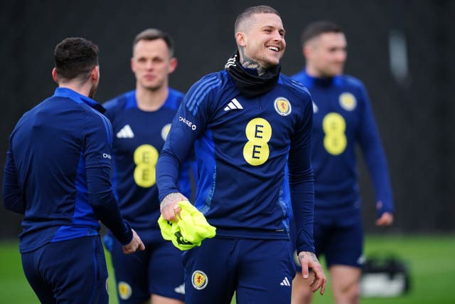 Lyndon Dykes laughs during a Scotland training session