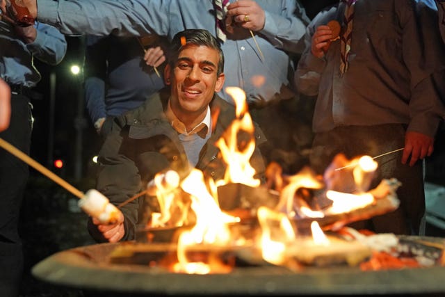 Prime Minister Rishi Sunak toasts marshmallows during a visit to the Sea scouts community group in Muirtown near Inverness