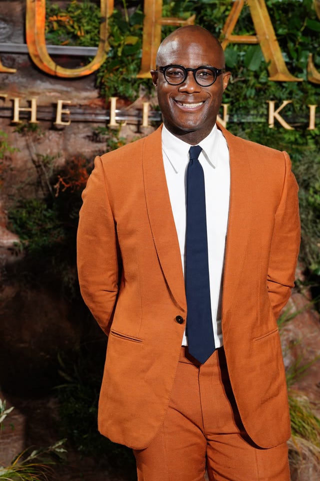 Director Barry Jenkins in an orange suit at the UK premiere of Seth Rogen