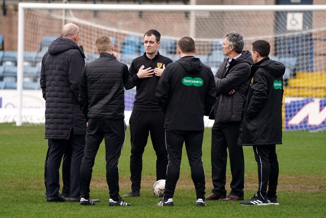 Referee Don Robertson speaks to officials and Rangers manager Philippe Clement before postponing the cinch Premiership match 