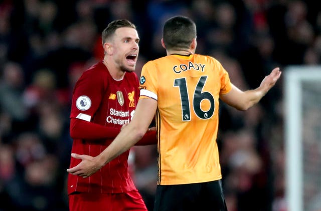 Conor Coady, right, and Liverpool’s Jordan Henderson exchange words after VAR disallows Neto’s goal 