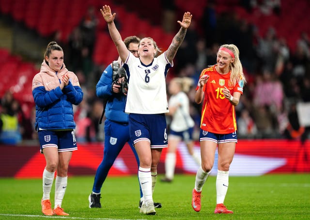 England defender Millie Bright, centre, celebrates with team-mates after the final whistle