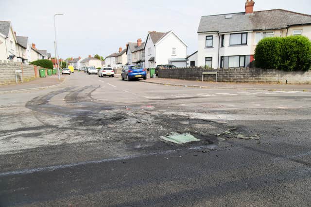 The damaged road surface where a car was set alight in Ely, Cardiff, following the riot that broke out after two teenagers died in a crash 