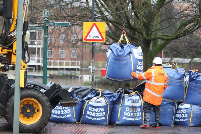 Workmen prepare flood defences near the River Ouse in York