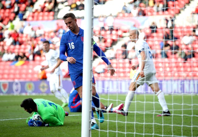 Jordan Henderson reacts after his penalty is saved by Romania goalkeeper Florin Nita, left
