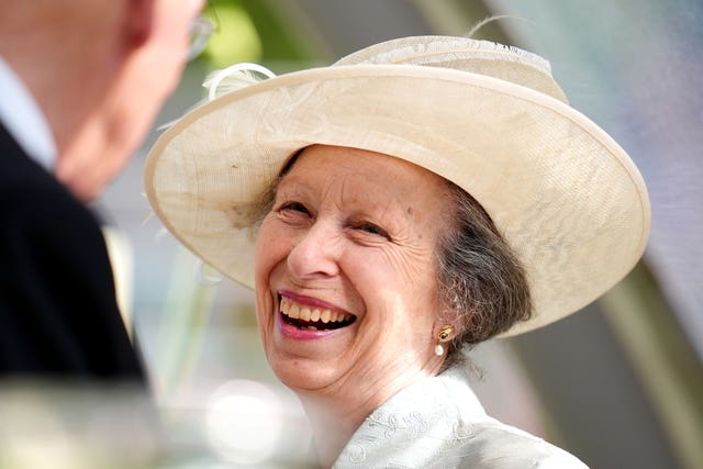 The Princess Royal laughing and wearing a hat