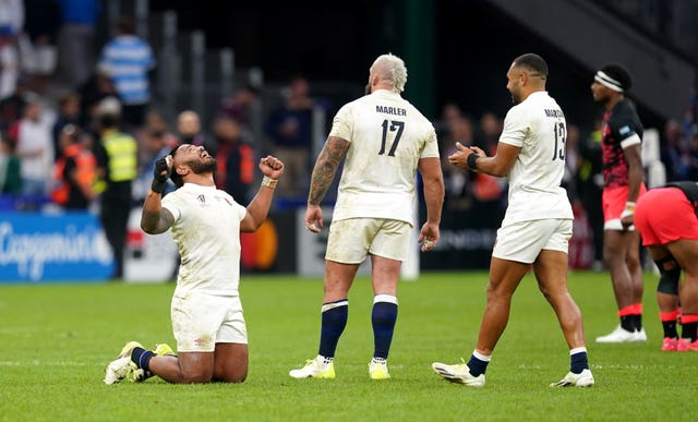 England’s Manu Tuilagi, left, celebrates victory over Fiji