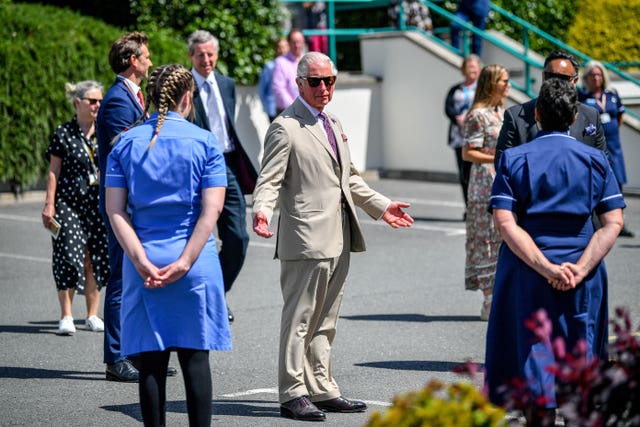 Charles chats to staff from St Austell Healthcare, seen as a model for future GP surgeries. Ben Birchall/PA Wire