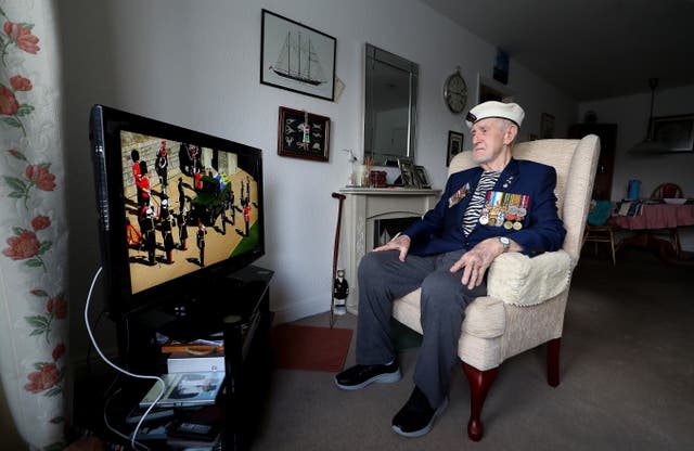 Malcolm Clerc, 94, watching the funeral on tv