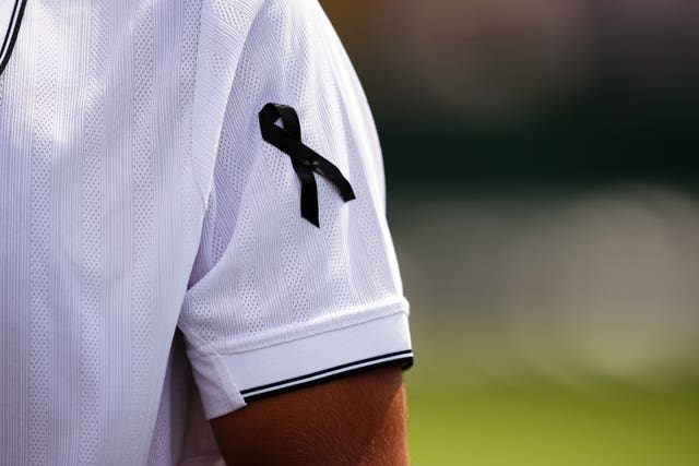 A close up of Francisco Cabral wearing a black ribbon 